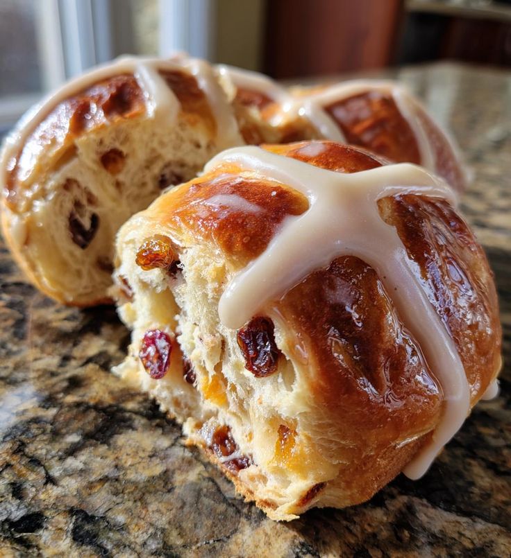 This may contain: two hot cross buns sitting on top of a counter