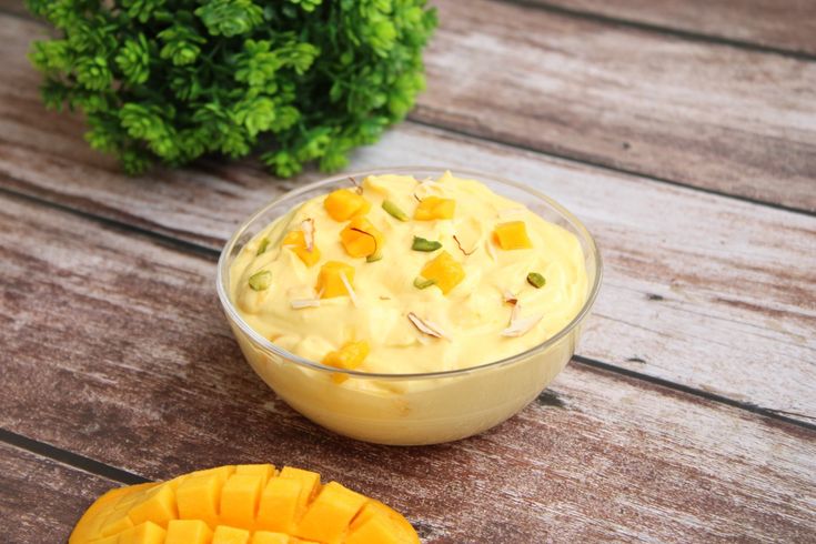 This may contain: a bowl of food sitting on top of a wooden table next to a cut up pineapple