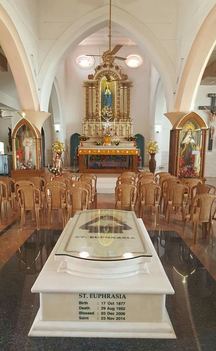 This may contain: the interior of a church with wooden chairs and an altar in the center surrounded by arches